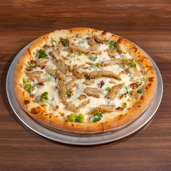 Di Leone's Italian Restaurant's chicken alfredo pizza with broccoli and bacon on a metal tray.