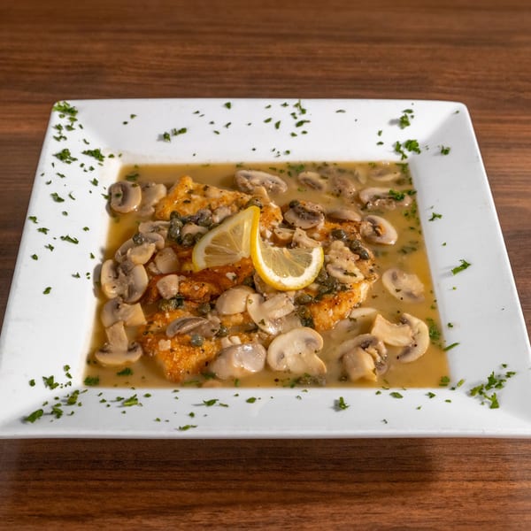 Di Leone's Italian chicken piccata with mushrooms, capers, and lemon slices in a rich sauce.