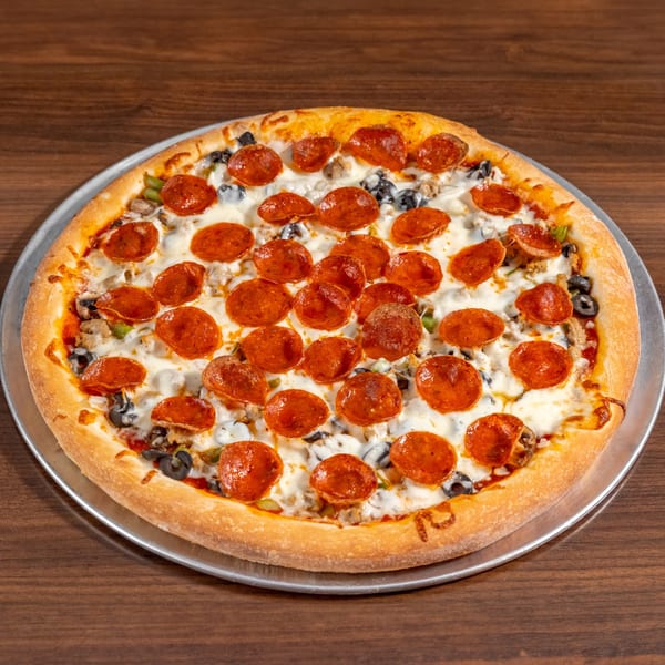 A whole pepperoni pizza with olives, mushrooms, and green peppers on a metal tray.